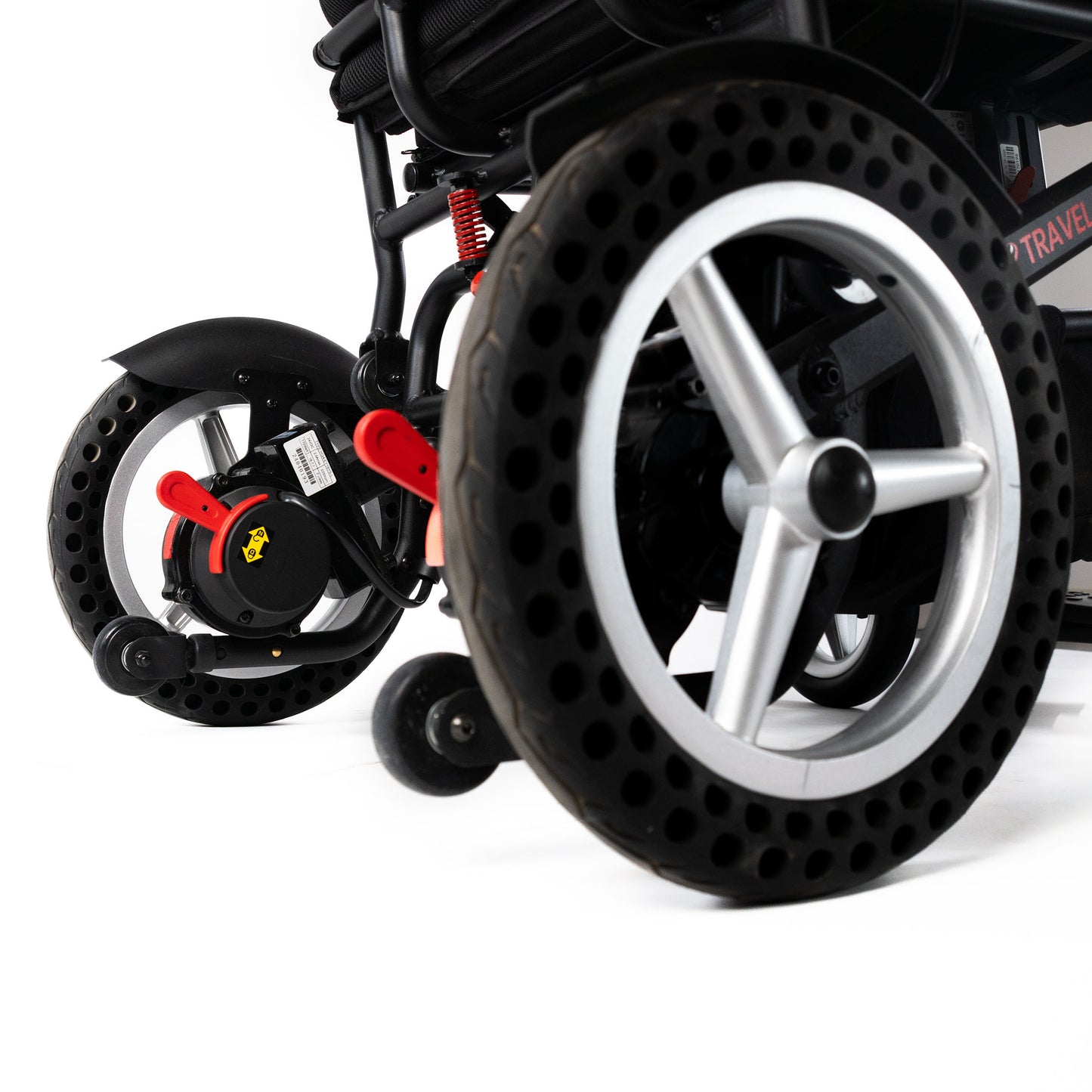 Right rear wheel and anti-tip wheel close-up on the Travel Buggy DASH folding power chair