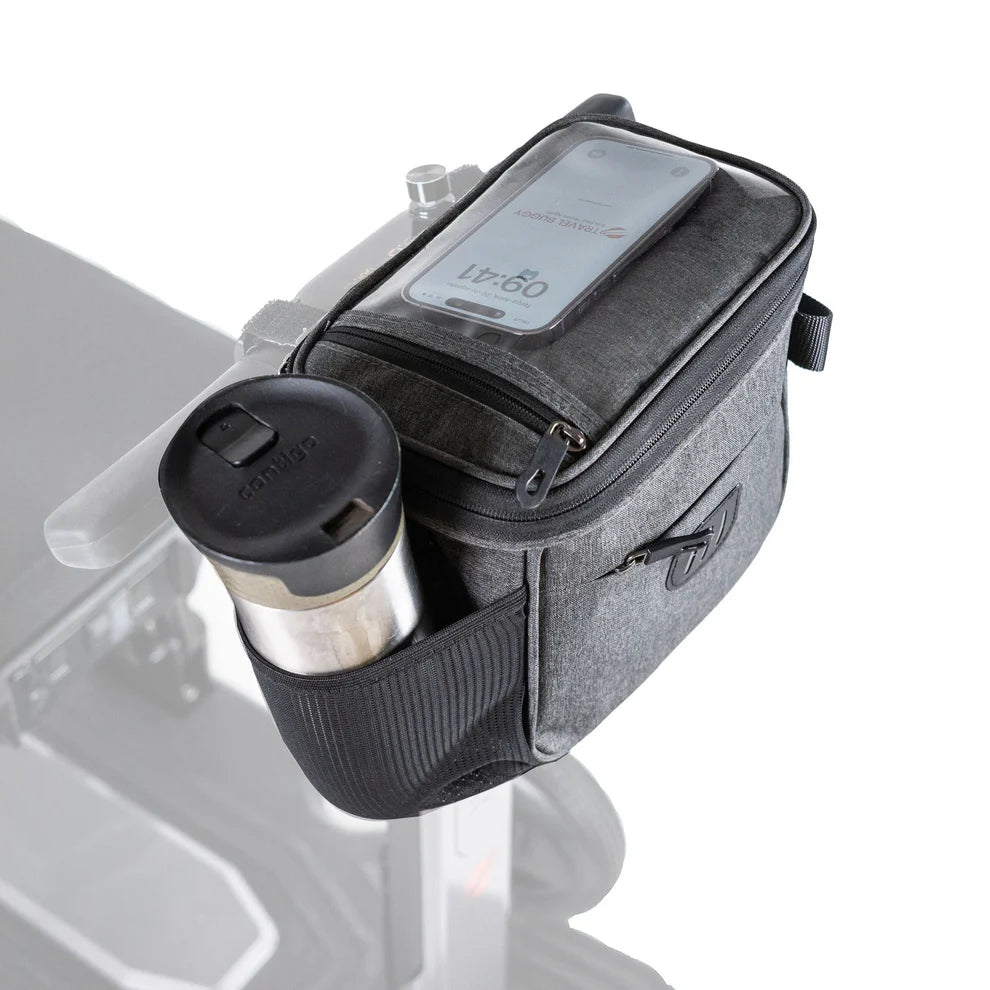 Travel Buggy Helix multifunctional bag securely mounted to a mobility scooter tiller, featuring an integrated bottle holder.