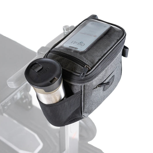Travel Buggy Helix multifunctional bag securely mounted to a mobility scooter tiller, featuring an integrated bottle holder.