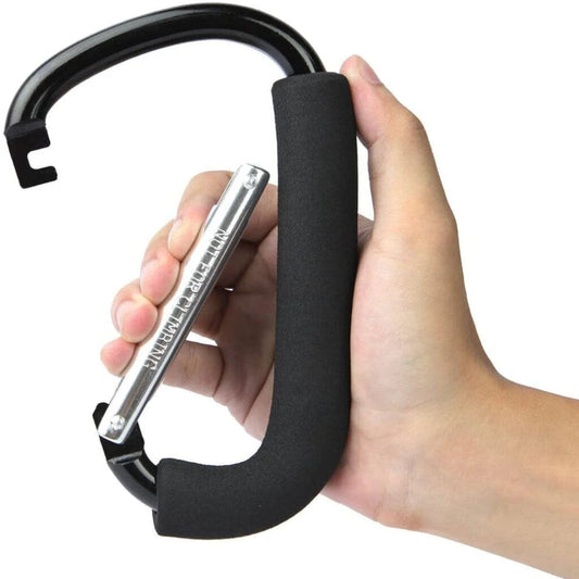 Hand holding the large Travel Buggy lightweight aluminum bag hook featuring a comfortable padded foam grip.