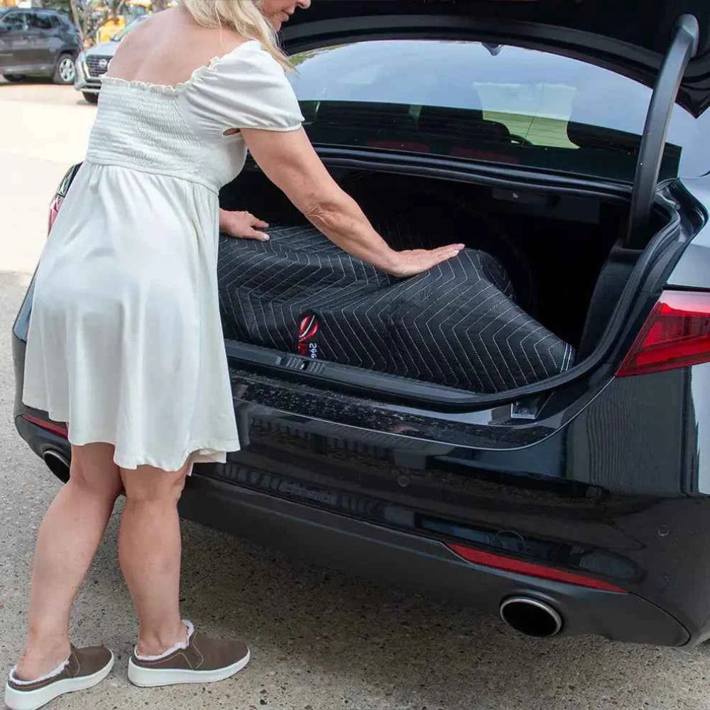 Power wheelchair safely loaded into a vehicle trunk using the Travel Buggy protective bumper mat.