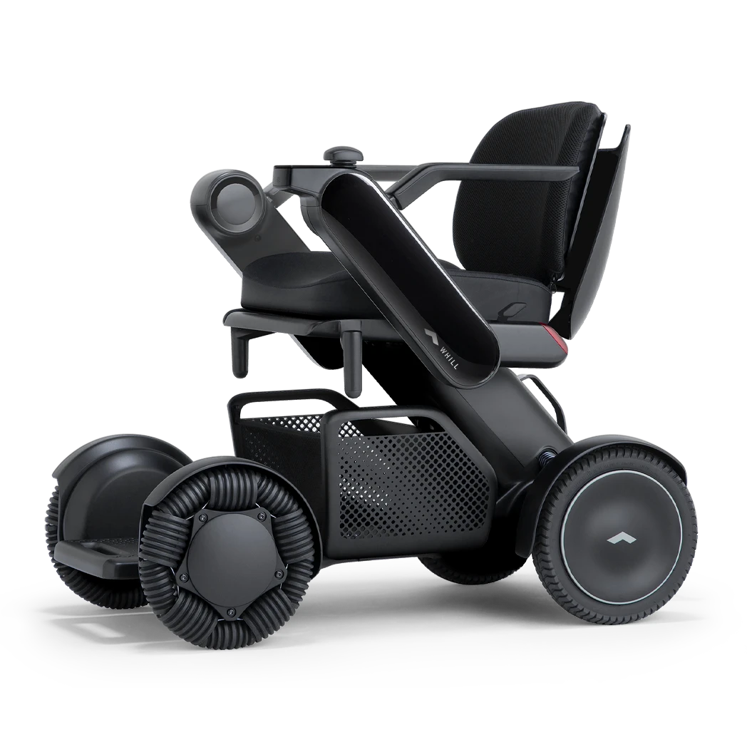 WHILL Model C2 power wheelchair with black arm covers, studio view