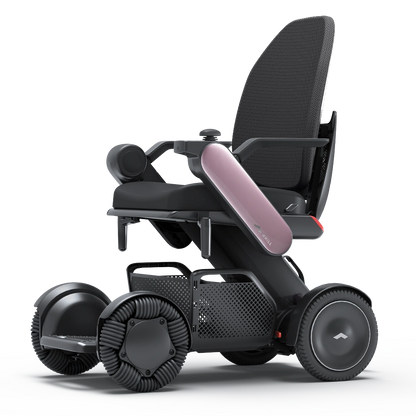 WHILL Model C2 High Back power wheelchair with pink arm covers, studio view