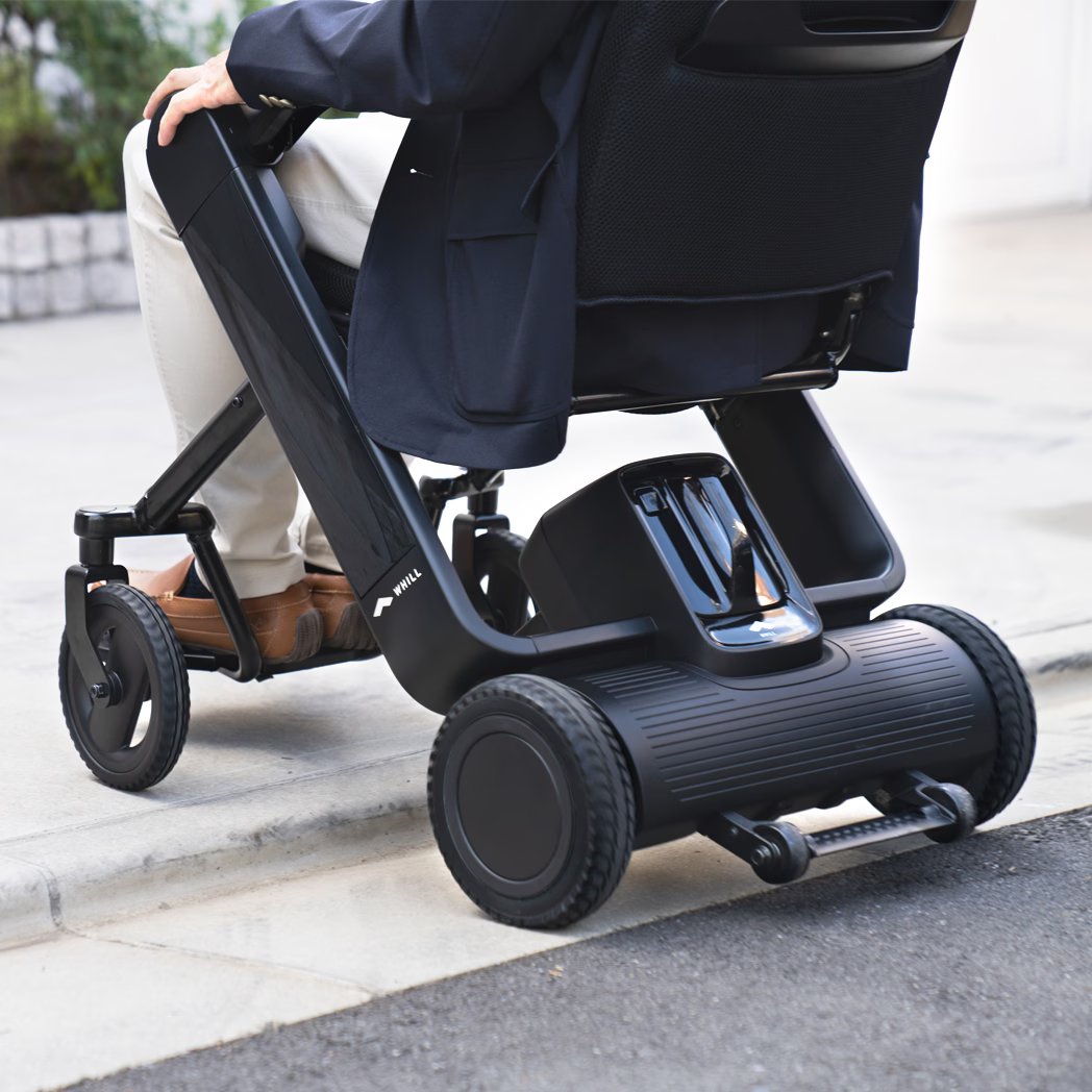 WHILL Model F folding power wheelchair in a lifestyle setting