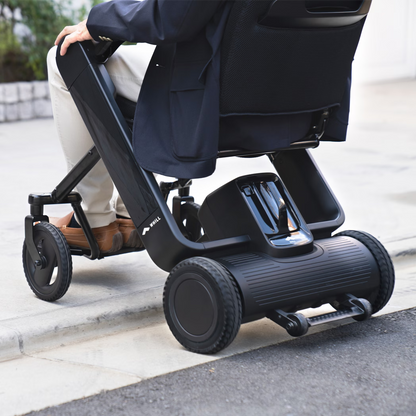 WHILL Model F folding power wheelchair in a lifestyle setting