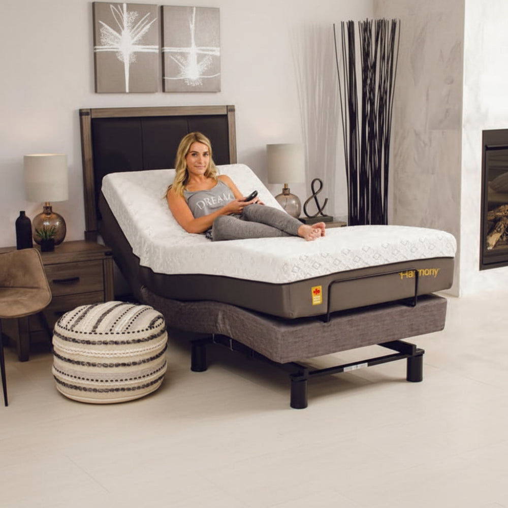 Woman reclining on a Harmony Relax mattress with the adjustable bed head raised