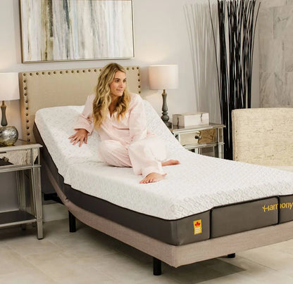 Woman comfortably relaxing on the Harmony Relax memory foam mattress while it is articulated on an adjustable bed frame.