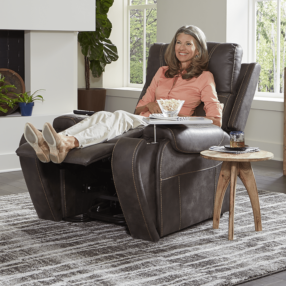 Lifestyle shot of a woman resting peacefully under a blanket in the fully reclined Golden Titan PL449 power chair.