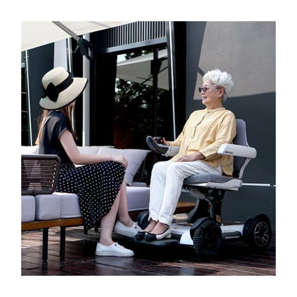 Lifestyle shot of a woman enjoying an outdoor patio space while seated in the comfortable Robooter X40 power chair.