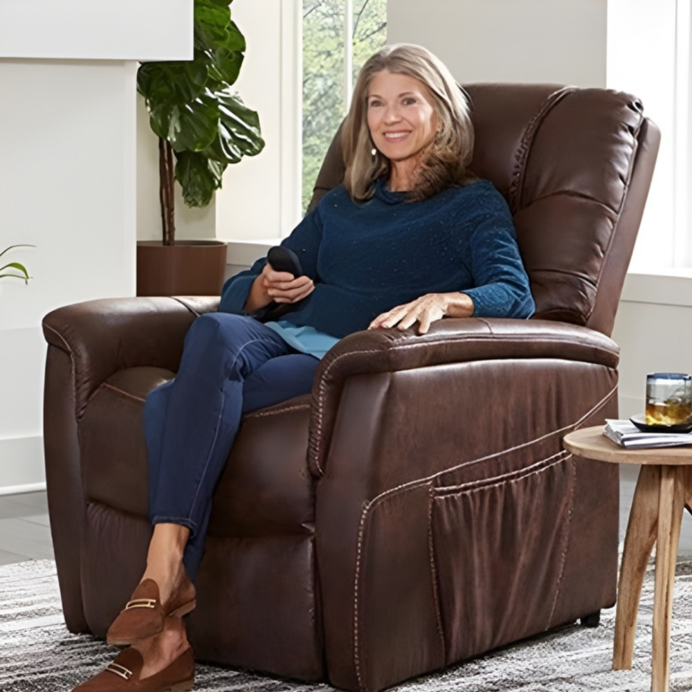 Lifestyle shot of a woman sitting upright in the Golden Dione lift chair while enjoying in a cozy living room.