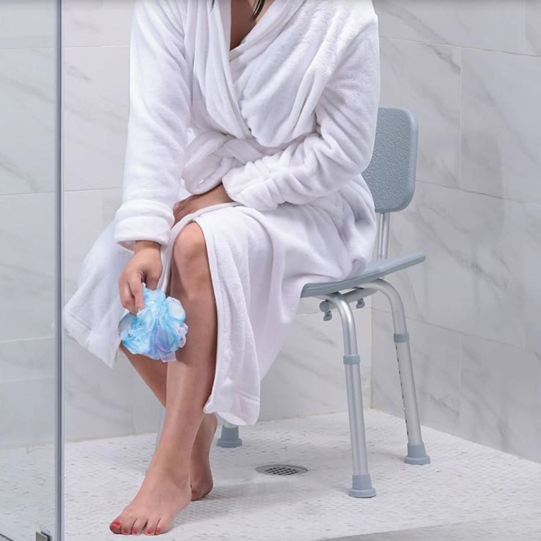 Lifestyle image of a woman in a bathrobe sitting securely on the Drive Medical bath chair inside a standard tub.