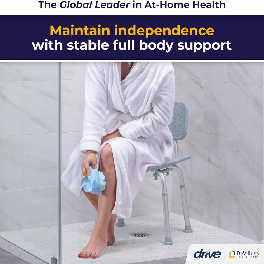 Lifestyle shot of a woman in a white robe safely and comfortably seated on the Drive Medical bath chair in a modern bathroom.