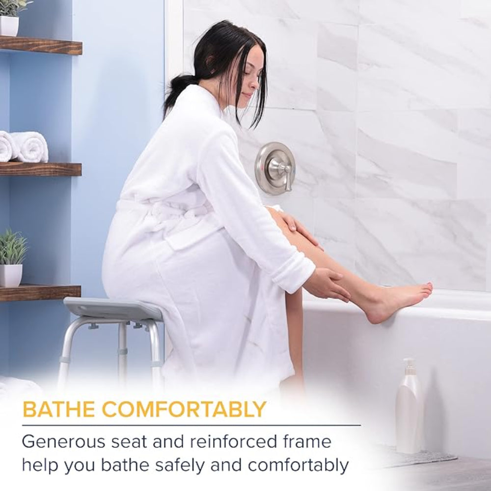 Lifestyle shot of a woman in a white robe preparing to safely use the Drive Medical Deluxe Aluminum Shower Bench in a bright, modern bathroom.