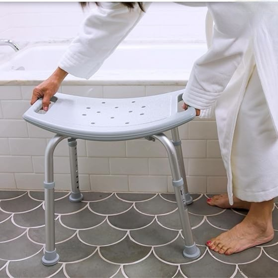 Lifestyle image showing a woman using Drive Medical aluminum shower bench.