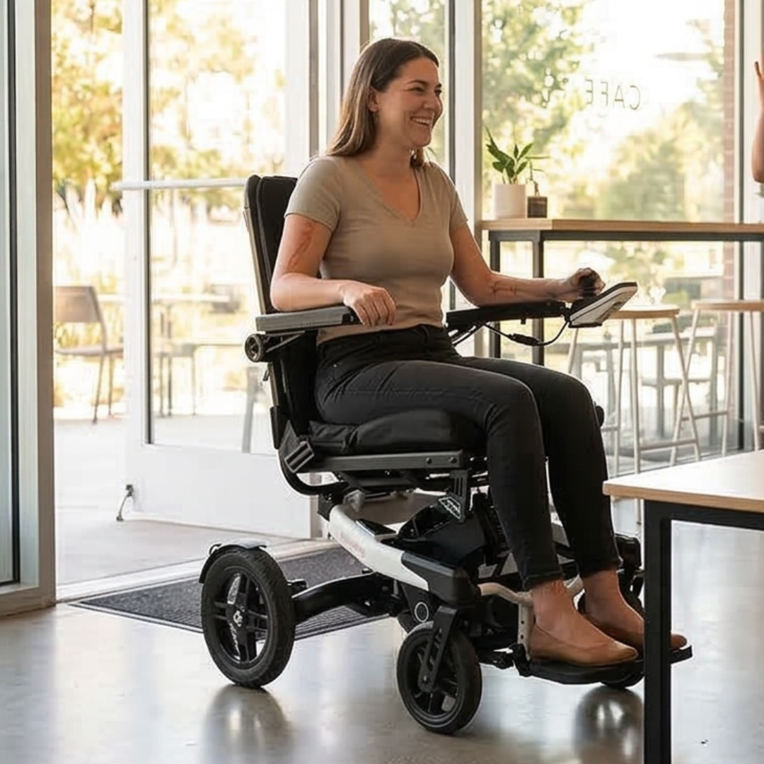 Lifestyle image of a woman easily navigating indoor using the Grand Tourer GT electric wheelchair.